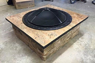 light brown backyard brick fire pit for smaller patios